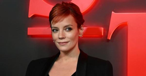 Lily Allen smiling while attending a Stranger Things event